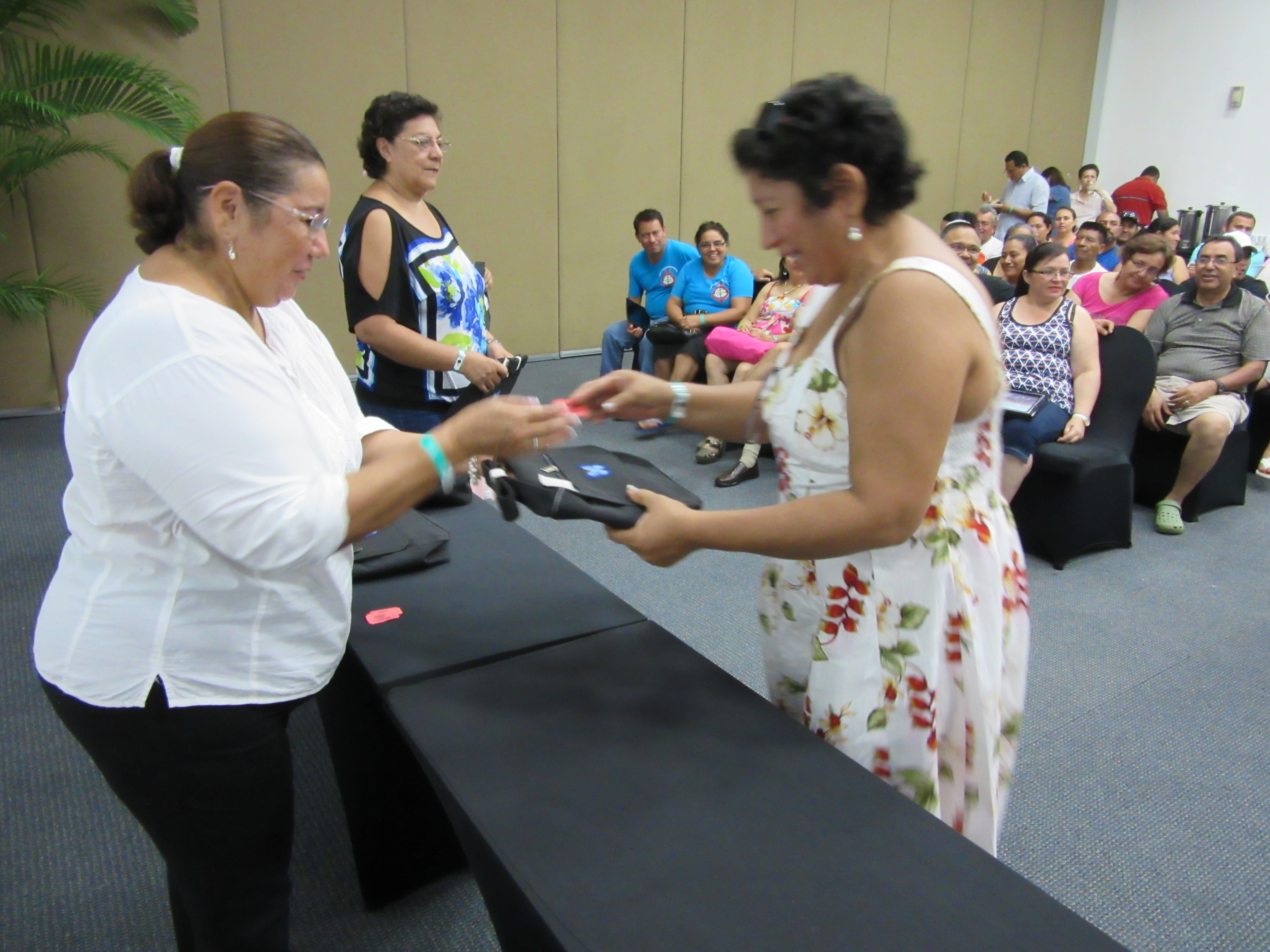 Sister Berali presenting purses donated for raffle